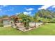 Backyard featuring a hammock, tropical plants, and a refreshing swimming pool perfect for relaxation and outdoor enjoyment at 8535 Plantation Ridge Blvd, Lakeland, FL 33809