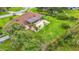 Spacious backyard featuring a sparkling screened-in pool, lush green lawn, and mature trees at 8535 Plantation Ridge Blvd, Lakeland, FL 33809