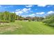 View of the lush backyard with a covered pool, landscaping, and plenty of green space at 8535 Plantation Ridge Blvd, Lakeland, FL 33809