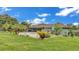 The backyard has a covered pool, outdoor furniture, and lush landscaping for relaxation and entertaining at 8535 Plantation Ridge Blvd, Lakeland, FL 33809