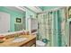 Well-lit bathroom features granite counters, ample storage space, and elegant shower curtain at 8535 Plantation Ridge Blvd, Lakeland, FL 33809