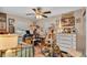 Bright bedroom boasts a large desk area, complemented by a ceiling fan and natural light at 8535 Plantation Ridge Blvd, Lakeland, FL 33809