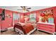 Charming bedroom featuring unique artwork, complemented by a ceiling fan and bright natural light at 8535 Plantation Ridge Blvd, Lakeland, FL 33809