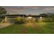 Charming home with an attached garage, lush landscaping, and a well-maintained yard at 8535 Plantation Ridge Blvd, Lakeland, FL 33809