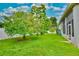 Lush backyard with mature trees and green grass at 943 Hamilton Place Ln, Lakeland, FL 33813