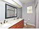 Bathroom featuring double sinks, granite countertop, tile floor and shower with tub at 943 Hamilton Place Ln, Lakeland, FL 33813