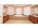 A luxurious bathroom with granite counter tops and a large soaking tub at 943 Hamilton Place Ln, Lakeland, FL 33813