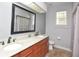 Bright bathroom showcasing double sinks, granite countertops, and modern fixtures at 943 Hamilton Place Ln, Lakeland, FL 33813