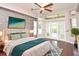 Bedroom with hardwood floors, large windows, double doors, and accent wall at 943 Hamilton Place Ln, Lakeland, FL 33813