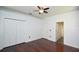 This bedroom has sleek hardwood floors, fresh paint, double closets, and a window for natural light at 943 Hamilton Place Ln, Lakeland, FL 33813