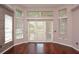 Bedroom with high windows, outdoor access, and dark hardwood floors at 943 Hamilton Place Ln, Lakeland, FL 33813