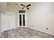 Spacious bedroom featuring a ceiling fan, grey vinyl floors, a walk-in closet and double doors at 943 Hamilton Place Ln, Lakeland, FL 33813
