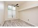 Well lit empty bedroom with a ceiling fan and gray vinyl flooring at 943 Hamilton Place Ln, Lakeland, FL 33813