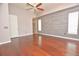 Bright bedroom with wooden accent wall, ceiling fan, and backyard access at 943 Hamilton Place Ln, Lakeland, FL 33813