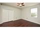 This bedroom features sleek hardwood floors, neutral paint, double closets, and a window for natural light at 943 Hamilton Place Ln, Lakeland, FL 33813