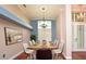 The dining room features hardwood floors, bright lighting, and modern decor for elegant dining at 943 Hamilton Place Ln, Lakeland, FL 33813