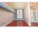 Dining room with an ornate chandelier, hardwood floors and access to other rooms at 943 Hamilton Place Ln, Lakeland, FL 33813