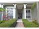 Close up view of home's front entrance with columns, tiled landing, and large windows at 943 Hamilton Place Ln, Lakeland, FL 33813