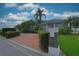 View of the front exterior and circular driveway, framed by mature landscaping at 943 Hamilton Place Ln, Lakeland, FL 33813