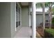 Covered front porch featuring tiled flooring and decorative columns at 943 Hamilton Place Ln, Lakeland, FL 33813