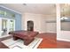 Game room with views to the outside, wood floors, and a glimpse to other rooms at 943 Hamilton Place Ln, Lakeland, FL 33813