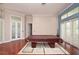 Spacious game room with hardwood floors, large windows, and french doors under elegant lighting at 943 Hamilton Place Ln, Lakeland, FL 33813