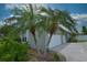 View of the side of the home with a two car garage and palm trees at 943 Hamilton Place Ln, Lakeland, FL 33813