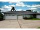 Spacious three-car garage and driveway providing ample parking space at 943 Hamilton Place Ln, Lakeland, FL 33813
