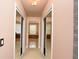 Hallway with two sliding mirrored closet doors leading to the Primary bathroom at 943 Hamilton Place Ln, Lakeland, FL 33813