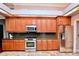 Well-equipped kitchen features granite counters, stainless steel appliances, and wood cabinets at 943 Hamilton Place Ln, Lakeland, FL 33813