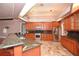 Kitchen with stainless steel appliances, granite countertops, and tile flooring at 943 Hamilton Place Ln, Lakeland, FL 33813