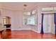 Bright living room features hardwood floors, large windows, and a chandelier at 943 Hamilton Place Ln, Lakeland, FL 33813