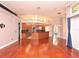 Spacious living room boasts an open floorplan with cherry hardwood floors and kitchen with black granite countertops at 943 Hamilton Place Ln, Lakeland, FL 33813
