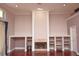 Cozy living room featuring a fireplace, built-in shelves, and hardwood floors at 943 Hamilton Place Ln, Lakeland, FL 33813