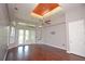 An empty living room with shiny hardwood floors and large windows to let in natural light at 943 Hamilton Place Ln, Lakeland, FL 33813