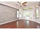 Bright room featuring hardwood floors, large windows, and double doors at 943 Hamilton Place Ln, Lakeland, FL 33813