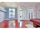 The living room boasts elegant chandeliers, hardwood floors, and a view of the front yard through glass french doors at 943 Hamilton Place Ln, Lakeland, FL 33813