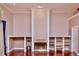 Cozy living room with a fireplace, built-in shelves, and hardwood floors at 943 Hamilton Place Ln, Lakeland, FL 33813