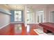 Spacious living area featuring hardwood floors, chandelier lighting, and an adjacent billiards room at 943 Hamilton Place Ln, Lakeland, FL 33813