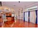Open-concept living room with hardwood floors, large windows, and access to kitchen at 943 Hamilton Place Ln, Lakeland, FL 33813