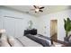 This primary bedroom has hardwood floors, neutral paint, double closets, and a dresser at 943 Hamilton Place Ln, Lakeland, FL 33813
