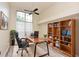 Bright home office with hardwood floors, stylish bookshelves, and a large window at 943 Hamilton Place Ln, Lakeland, FL 33813