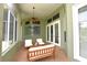 This screened-in patio features comfortable outdoor seating, ceiling fans, and a brick floor at 943 Hamilton Place Ln, Lakeland, FL 33813