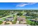 Aerial view showcasing a home with a lush green yard, above ground pool, and mature trees at 1034 Shadowbrook N Dr, Lakeland, FL 33813