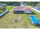 Aerial view of a home with a large screened in patio and above ground pool at 1034 Shadowbrook N Dr, Lakeland, FL 33813