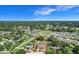Expansive aerial view showcasing property, surrounding neighborhood, and scenic pond at 1034 Shadowbrook N Dr, Lakeland, FL 33813