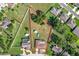 Aerial view of a home with a large lot, shed, above ground pool, and screened-in porch at 1034 Shadowbrook N Dr, Lakeland, FL 33813