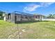 The backyard features a screened patio and lush lawn at 1034 Shadowbrook N Dr, Lakeland, FL 33813