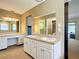 Spacious bathroom featuring double sinks and vanities with framed mirrors at 1034 Shadowbrook N Dr, Lakeland, FL 33813