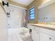 Bathroom featuring a shower/tub with a curtain and vanity with white cabinets and granite countertops at 1034 Shadowbrook N Dr, Lakeland, FL 33813